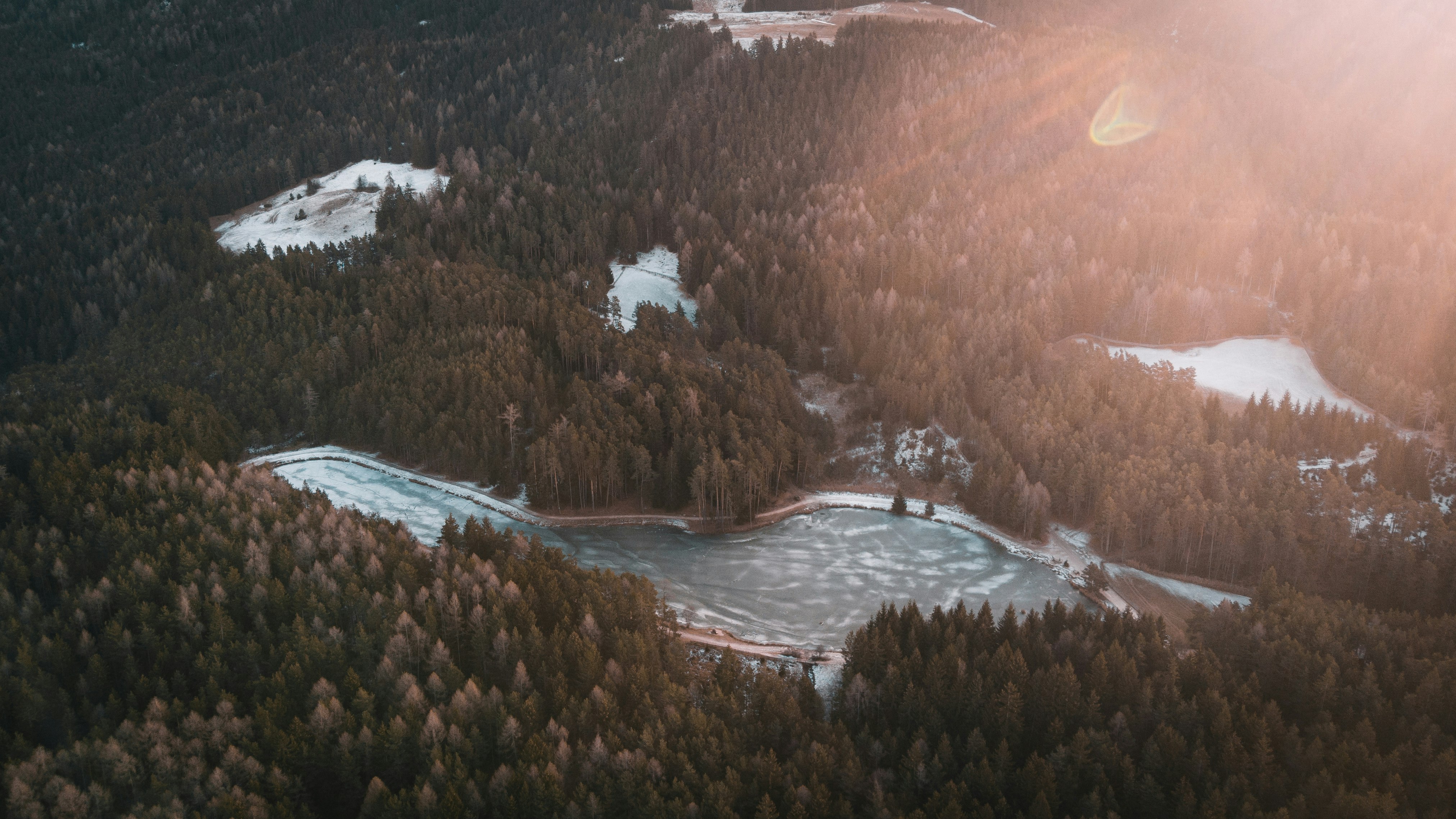 birds eye photography of body of water near forest